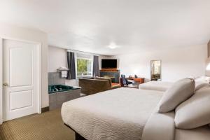 a hotel room with two beds and a pool table at Days Inn by Wyndham Valemount in Valemount +68 photos