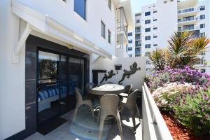a patio with a table and chairs on a balcony at Barefoot Bliss in Rockingham