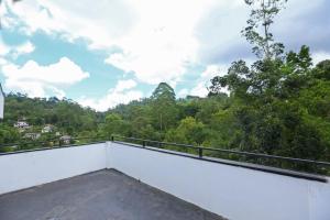 a balcony with a view of the forest at Lush Home in Bandarawela