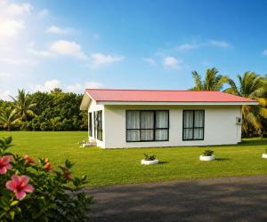 a small white house with a red roof at Mouare Hideaway in Arutanga