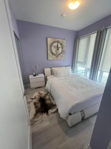 a bedroom with a bed with a rug on the floor at Downtown Luxury Condo Gym & Parking in Toronto +35 photos