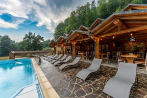 a resort with a swimming pool and a restaurant at Barlogul Ursului in Baia Mare