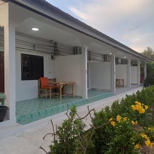 a villa with a swimming pool and a patio at P & T Guesthouse in Bangrak Beach