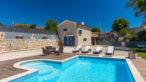 a villa with a swimming pool and a house at Lukini dvori by Villas Guide in Bibići