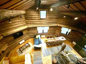 an overhead view of a living room in a log cabin at Villa Pukelo Arctic Lodge with wifi sauna 4 poster bed fireplace in Salla