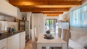 a kitchen and dining room with a table and chairs at Lukini dvori by Villas Guide in Bibići