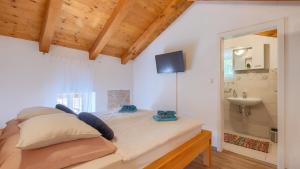 a bedroom with a bed with a sink and a mirror at Lukini dvori by Villas Guide in Bibići +47 photos