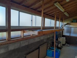 an empty room with windows in a building at 民宿なかやま in Kushimoto