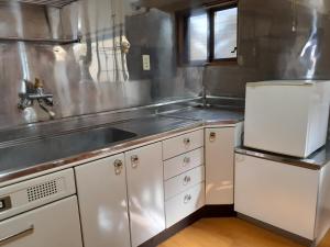 a kitchen with a sink and a counter top at 民宿なかやま in Kushimoto