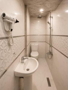 a bathroom with a toilet and a sink at Kennedy Apart Hotel Kumkapı Istanbul in Istanbul