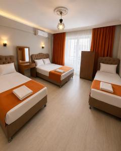 a hotel room with two beds and a window at Kennedy Apart Hotel Kumkapı Istanbul in Istanbul