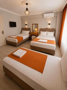 a hotel room with two beds and a television at Kennedy Apart Hotel Kumkapı Istanbul in Istanbul