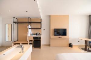 a large living room with a sink and a television at The Sea Beach Residences - Arena Cam Ranh Resort in Cam Ranh International Airport