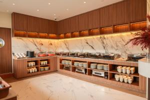 a restaurant kitchen with a counter with food at Newly Renovated - Days Inn by Wyndham Singapore Novena in Singapore