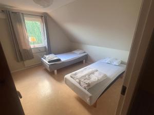 two beds in a small room with a window at Villa Konga in Konga +20 photos