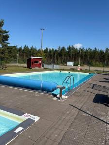 a large swimming pool with a blue tube in it at Villa Konga in Konga