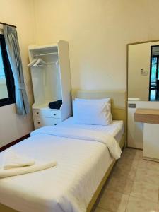 a bedroom with two beds and a mirror at Coconut hill villa in Trat