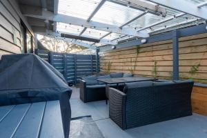 a patio with tables and chairs in a building at The Rye Reset in Rye