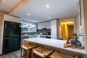 a kitchen with a white counter and a black refrigerator at The Rye Reset in Rye