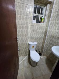 a bathroom with a toilet and a sink at PiemStays in Ruaka +2 photos