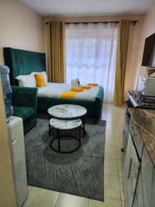 a living room with a couch and a table at PiemStays in Ruaka