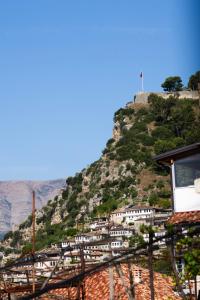 a mountain with white houses on a hill at Vila Blin in Berat