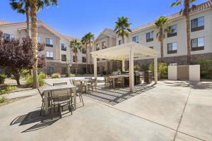 a patio with tables and chairs in front of a building at Homewood Suites Lancaster in Lancaster