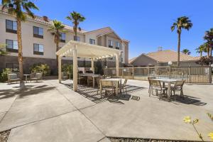a patio with tables and chairs in front of a building at Homewood Suites Lancaster in Lancaster