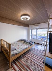 a bedroom with a bunk bed in a room at Kame Ame House in Kameoka