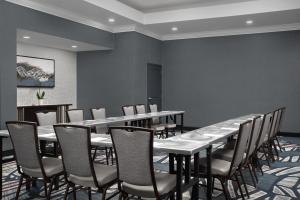 a dining room with tables and chairs and a wall at Embassy Suites by Hilton Birmingham Hoover in Birmingham +28 photos