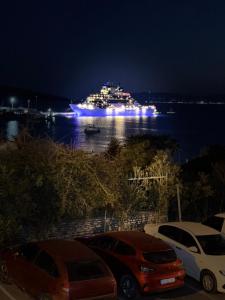 a cruise ship in the water at night at DORTMEVSİM Hotel in Bodrum City