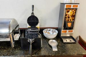 a kitchen counter with a mixer and other kitchen items at Comfort Inn Mount Vernon Downtown in Mount Vernon