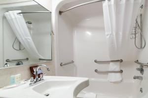 a white bathroom with a sink and a shower at Quality Inn & Suites Colby in Colby +55 photos