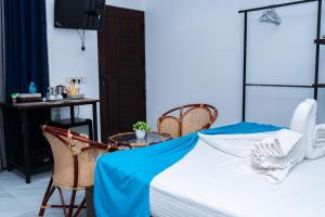 a bedroom with a bed and a table and chairs at Aathi Resort in Trincomalee +45 photos