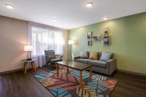 a living room with a couch and a table at WoodSpring Suites Knoxville West in Knoxville