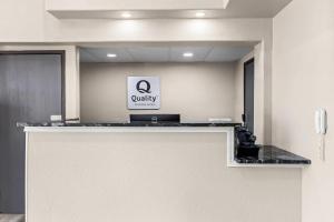 an office with a counter with a qualify sign on the wall at Quality Inn Oskaloosa in Oskaloosa
