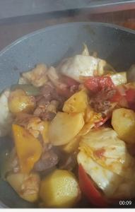 a pot of food with potatoes and other vegetables at Azamat Yurt Camp in Song-Kul