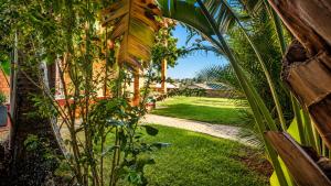 a view of a yard with palm trees and grass at Villa de standing à Ivato in Antananarivo