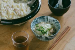 a table with a bowl of food and a glass of beer at 暇家 kaya in Yosano +6 photos