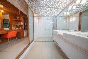 a bathroom with two sinks and a large mirror at Pattaya Bungalow III, Totally Private Pool in Pattaya South +18 photos