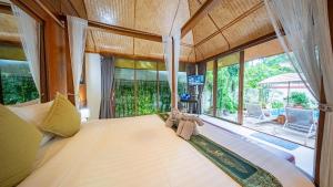 a bedroom with a large bed with two teddy bears on it at Pattaya Bungalow III, Totally Private Pool in Pattaya South