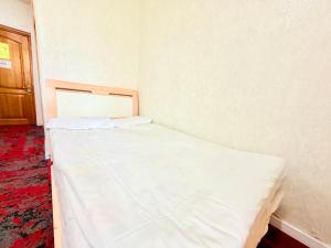 a small bedroom with a white bed in it at City Hostel & Tours in Ulaanbaatar
