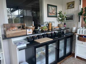 a kitchen with a black counter with dishes on it at Lindum Hotell in Suldalsosen +30 photos