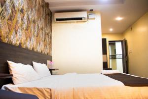 a hotel room with a bed and a air conditioner at Aira Suites in Bangalore