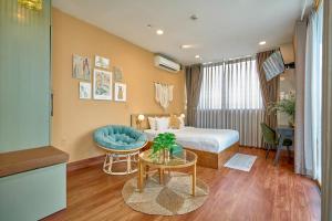 a hotel room with a bed and a table at Cactusland Boutique Hotel in Ho Chi Minh City