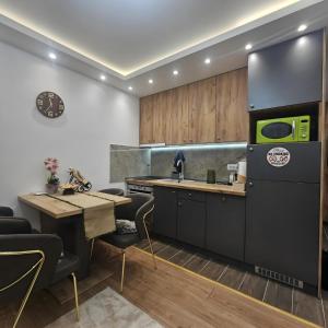 a kitchen with a counter and a table and chairs at Stan na dan Bijeljina centar 2 in Bijeljina