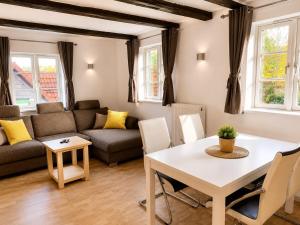 a living room with a table and a couch at Alte Faktorei Schierke in Schierke