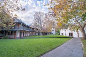 an exterior view of a house with a lawn at St Francis Winery in Old Reynella