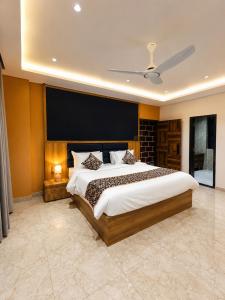 a bedroom with a large bed and a large screen at Kaya Nature Resort in Ajabgarh