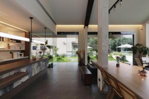 a large room with a stone wall and a lobby at Chyanmu Hidden Village Retreat Near The Grand Canyon of Zhangjiajie and Yellow Dragon Cave With Local Culture Village Life Breakfast Quiet Wellness Escape for Urban Travelers Seeking Privacy and Peace in Zhangjiajie